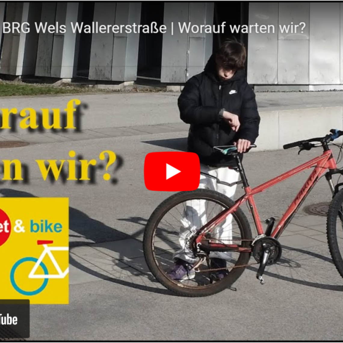 Jugendlicher mit Fahrrad vor Schule, wartet