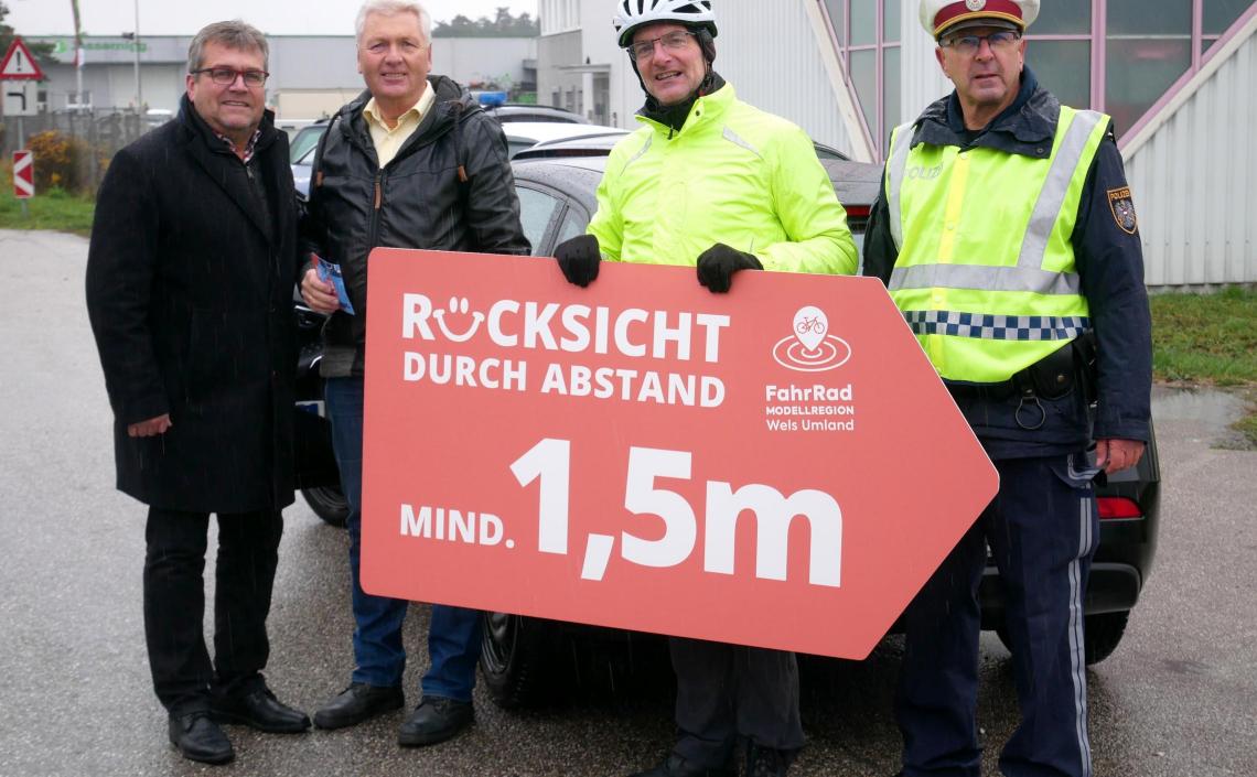 Vier Männer mit Rücksicht durch Abstand Schild